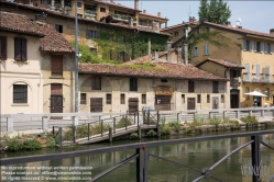 Viennaslide-06631105 Der Naviglio Grande ist der älteste Naviglio (Kanal) Mailands.
Er wurde in den Jahren 1177 bis 1257 gebaut und bezieht sein Wasser aus dem Ticino (Tessin). Über 50 km lang, diente er als Transportweg zwischen Mailand und dem Lago Maggiore (und somit auch der Schweiz). Die für den Bau des Domes benötigten Marmorblöcke, aber auch Schüttgüter wie Kohle wurden auf ihm verschifft, wobei Lastkähne durch den Kanal gestakt wurden. In den 1960er Jahren wurde der Transportverkehr eingestellt.
Der Naviglio wird heute als Wasserspender für die Landwirtschaft genutzt. Am Ende des Kanals (in Mailand) haben sich an beiden Ufern etliche Kneipen und Restaurants etabliert, die abends und am Wochenende gut besucht sind.