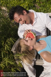 Viennaslide-72000179 Junges Paar isst eine Wassermelone im Freien - Young couple eating watermelon outdoors