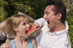Viennaslide-72000180 Junges Paar isst eine Wassermelone im Freien - Young couple eating watermelon outdoors